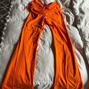 Orange, flared, scrunched butt and side pants.